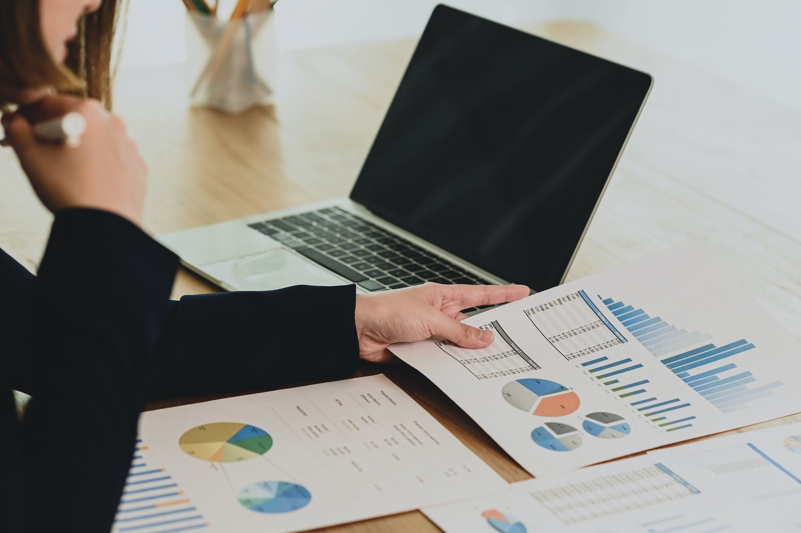 Businesswoman analyzing business data from graphs.