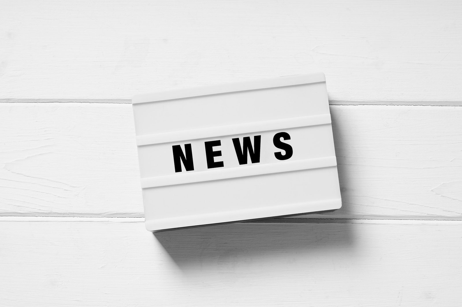 news text on light box sign on white wooden background
